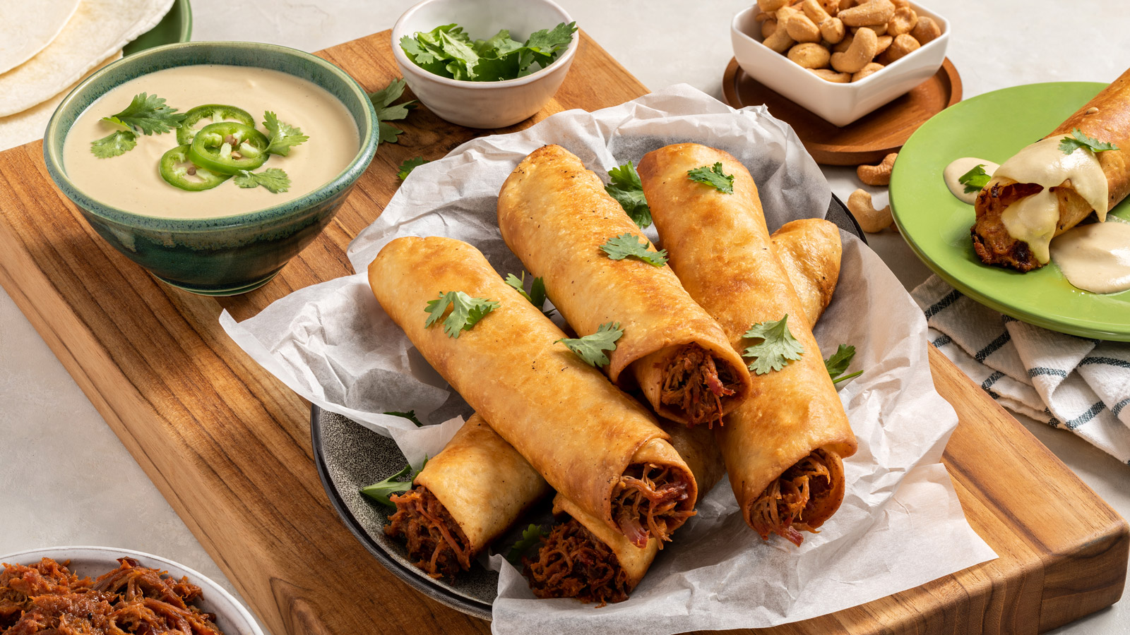 Platter of BBQ taquitos with cashew queso.