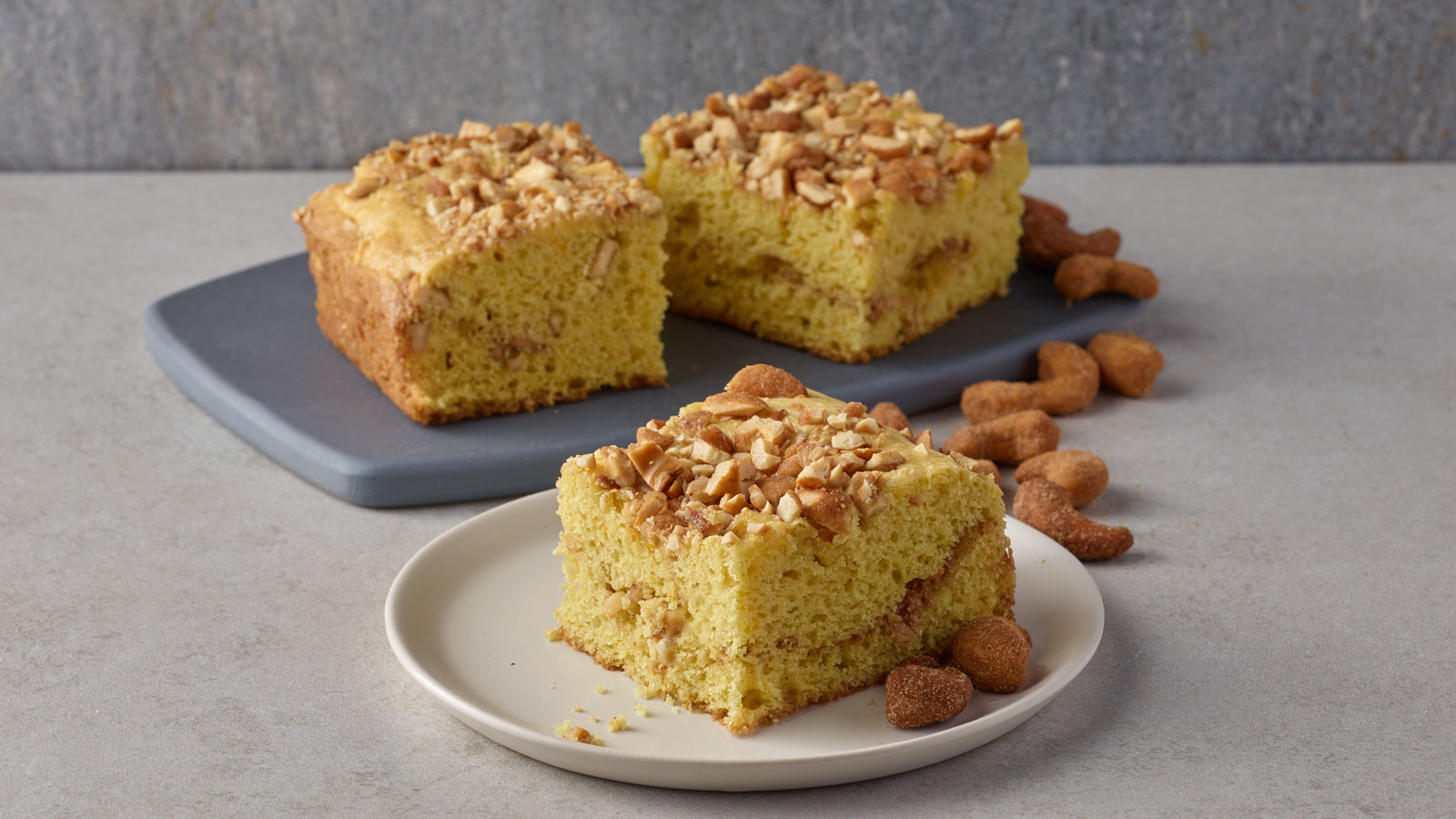 Small plates with cinnamon brown sugar cashew coffee cake pieces.