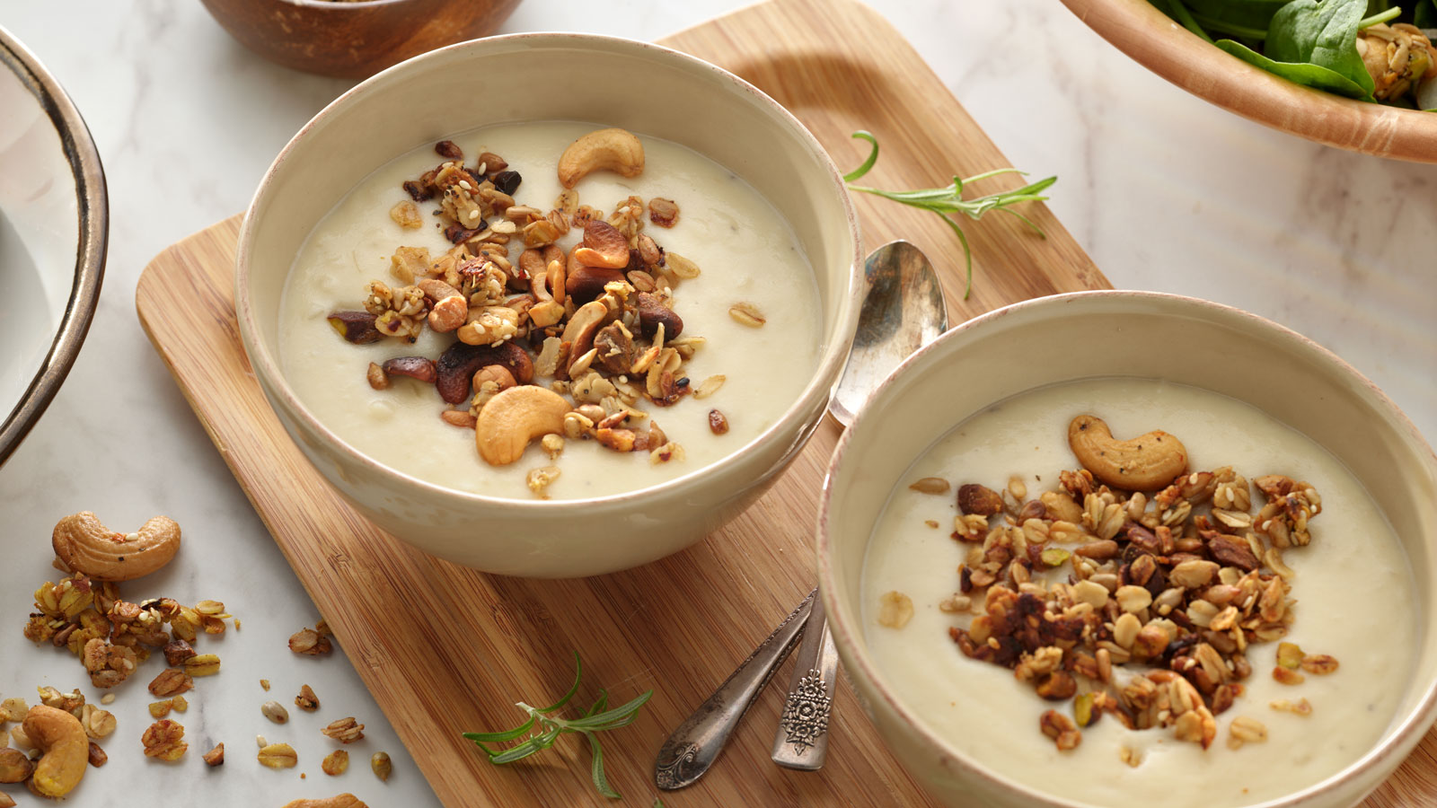 Bowls of mashed potato soup topped with savory granola.