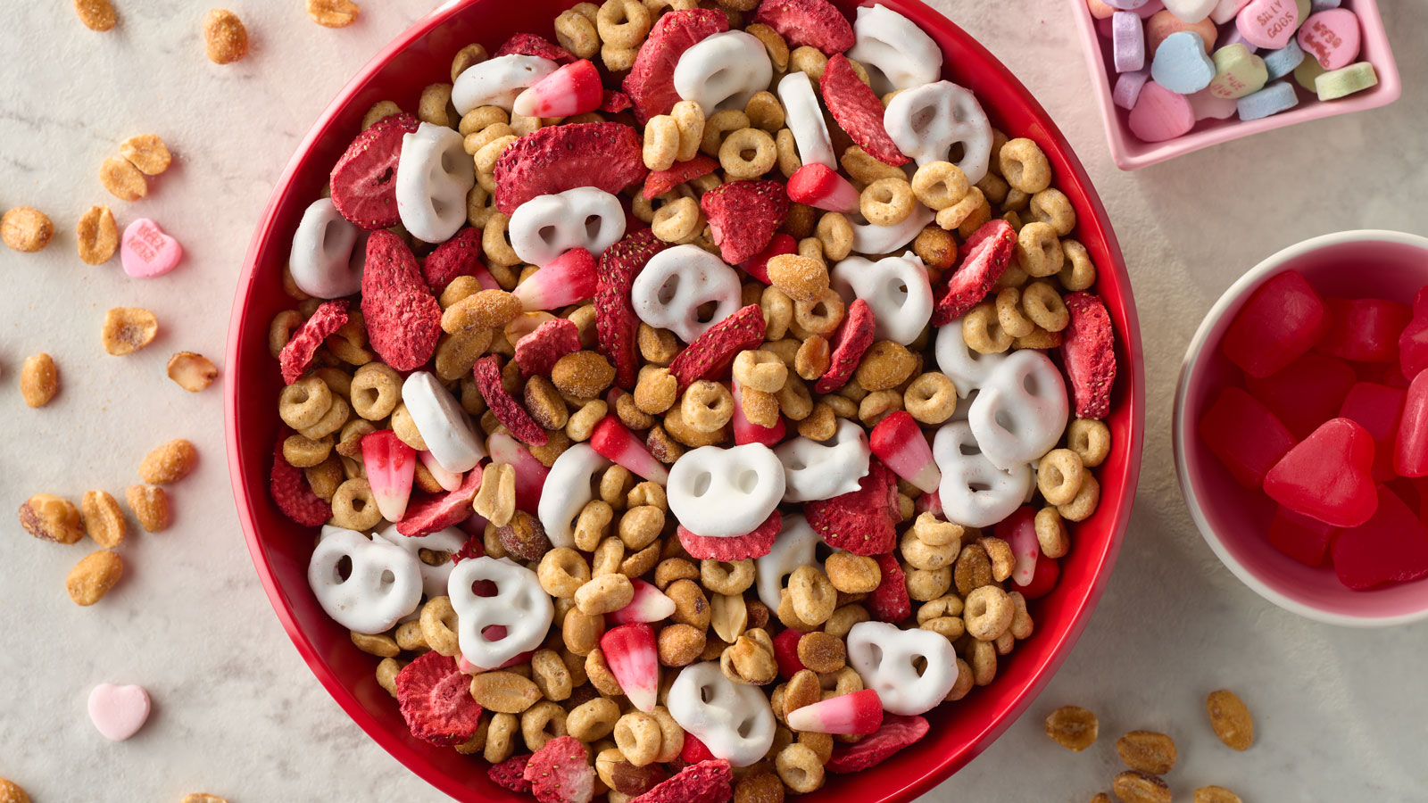 Red bowl full of PLANTERS Valentine snack mix.
