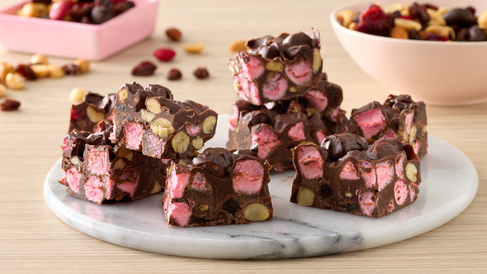 Indulge in the festive spirit with Holiday Nut Crunch Rocky Road, a delightful treat ready in just 30 minutes. Combining the velvety richness of chocolate and festive crunch of PLANTERS® Limited Edition Holiday Nut Crunch and marshmallows, result in bars that burst with holiday flavor and irresistible sweetness, making each bite a delightful celebration for your taste buds.