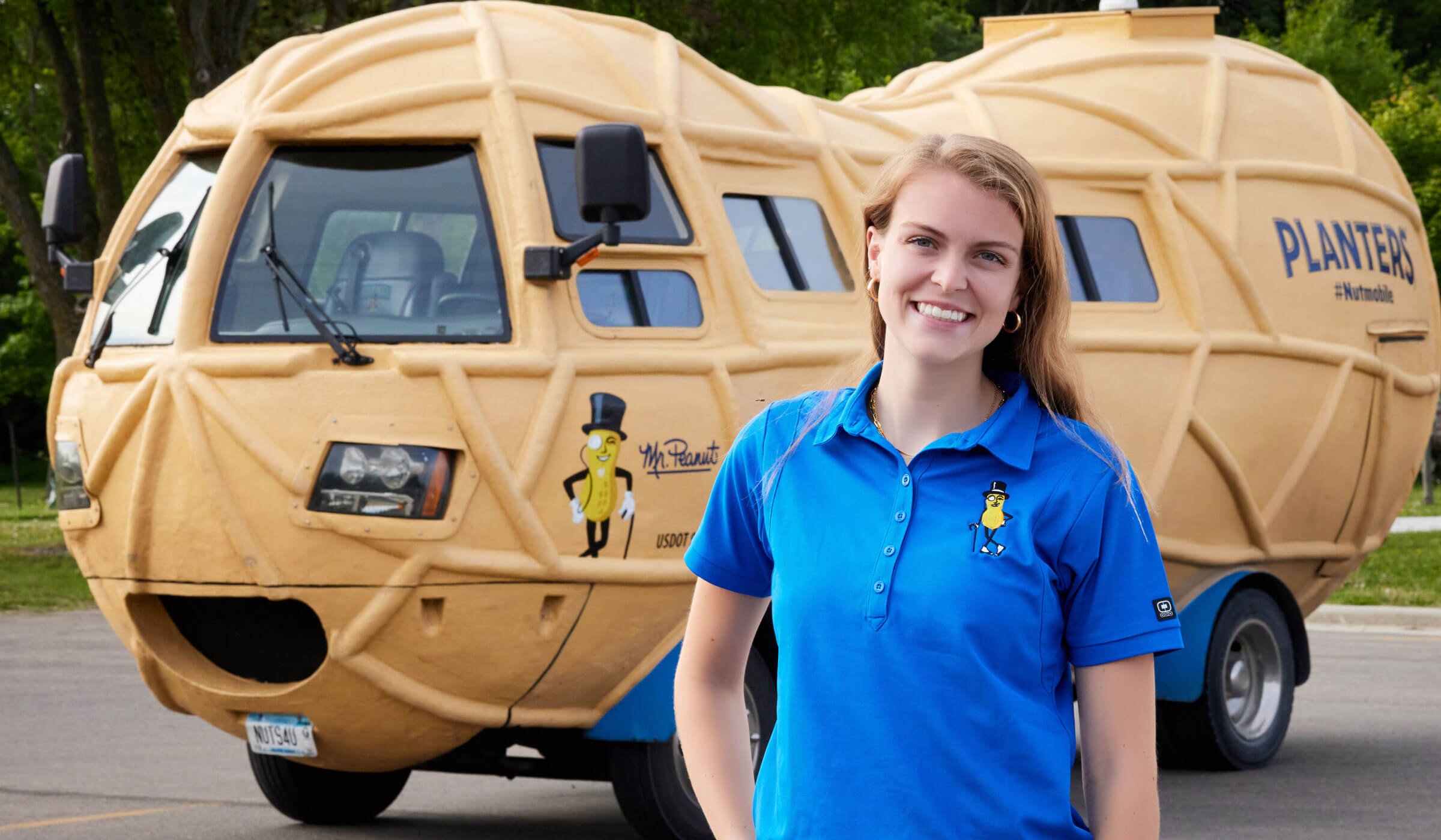 Lady smiling in front of the planters Nutmobile