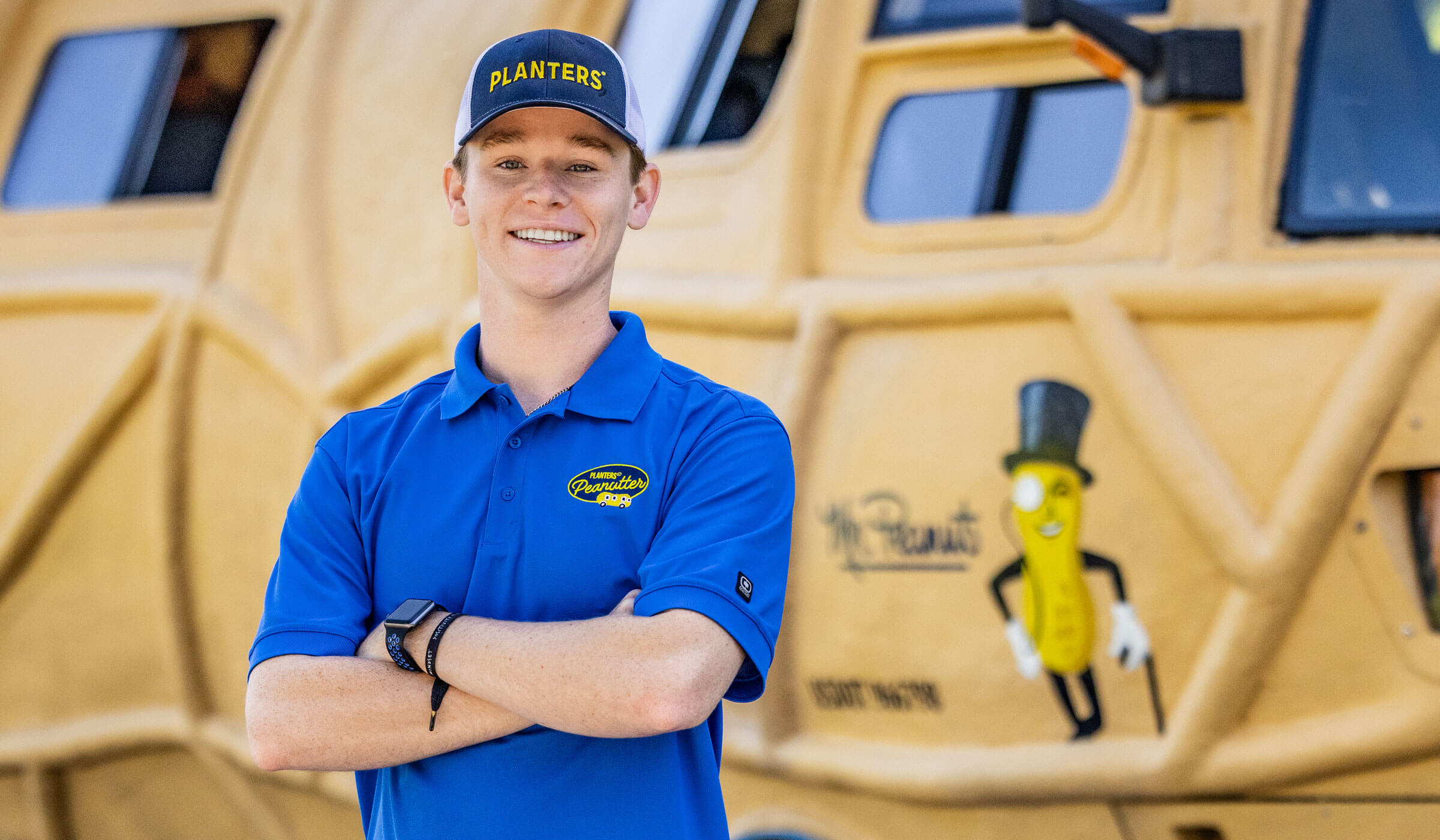 Man smiling in front of the planters nutmobile