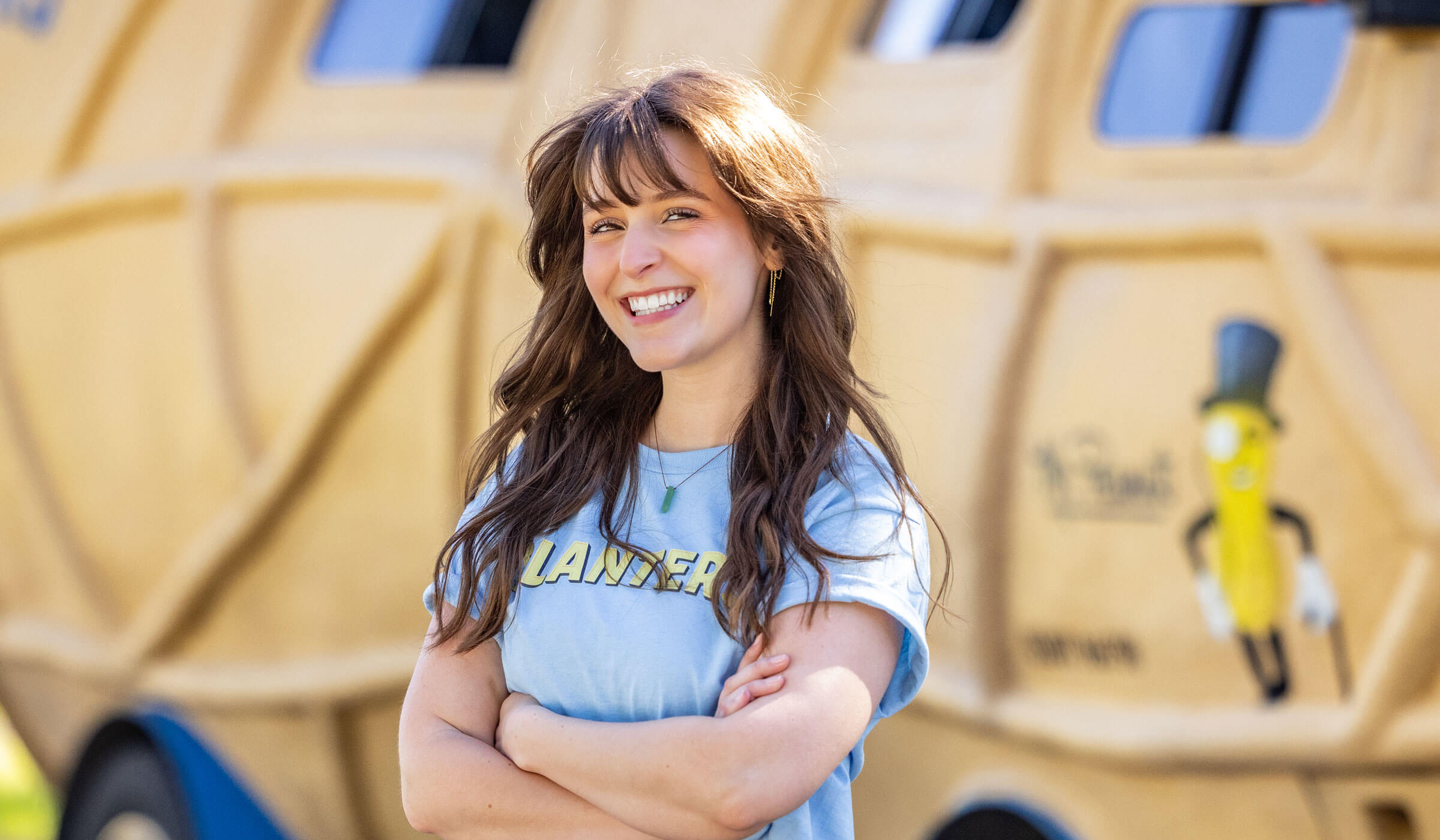 Lady smiling in front of the planters nutmobile