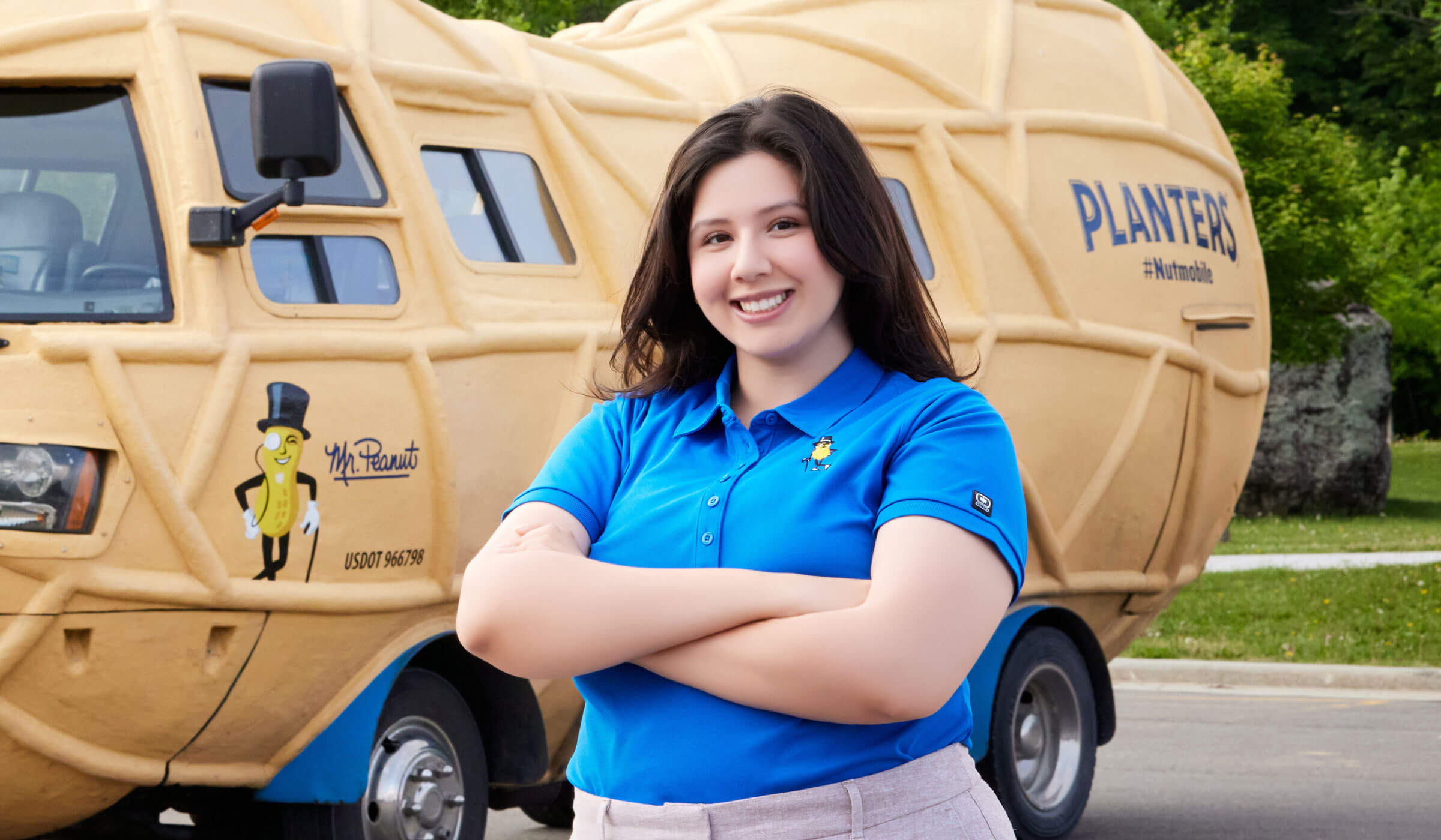 Lady smiling in front of the planters nutmobile
