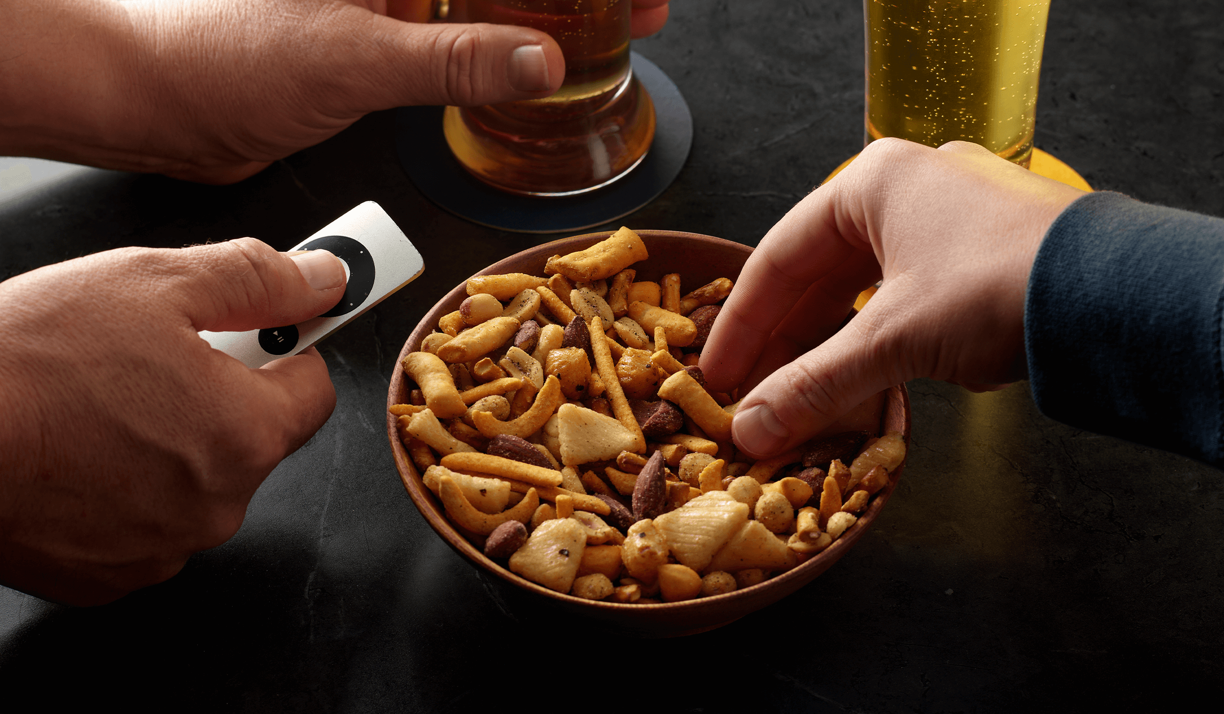 People sharing the miller high life and planters bar nut mix with beers