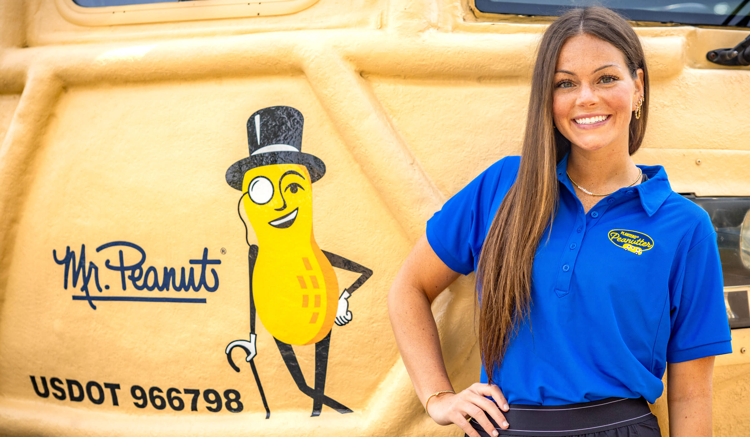 Lady smiling in front of the Planters Nutmobile