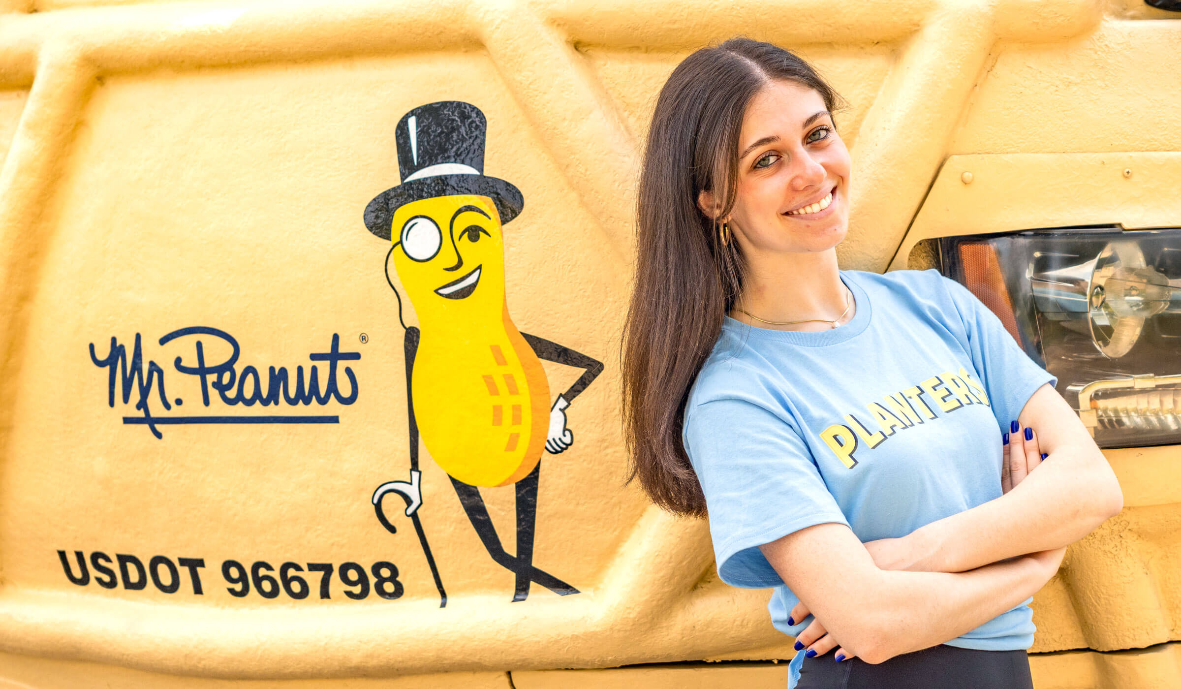 Lady smiling in front of the Planters Nutmobile