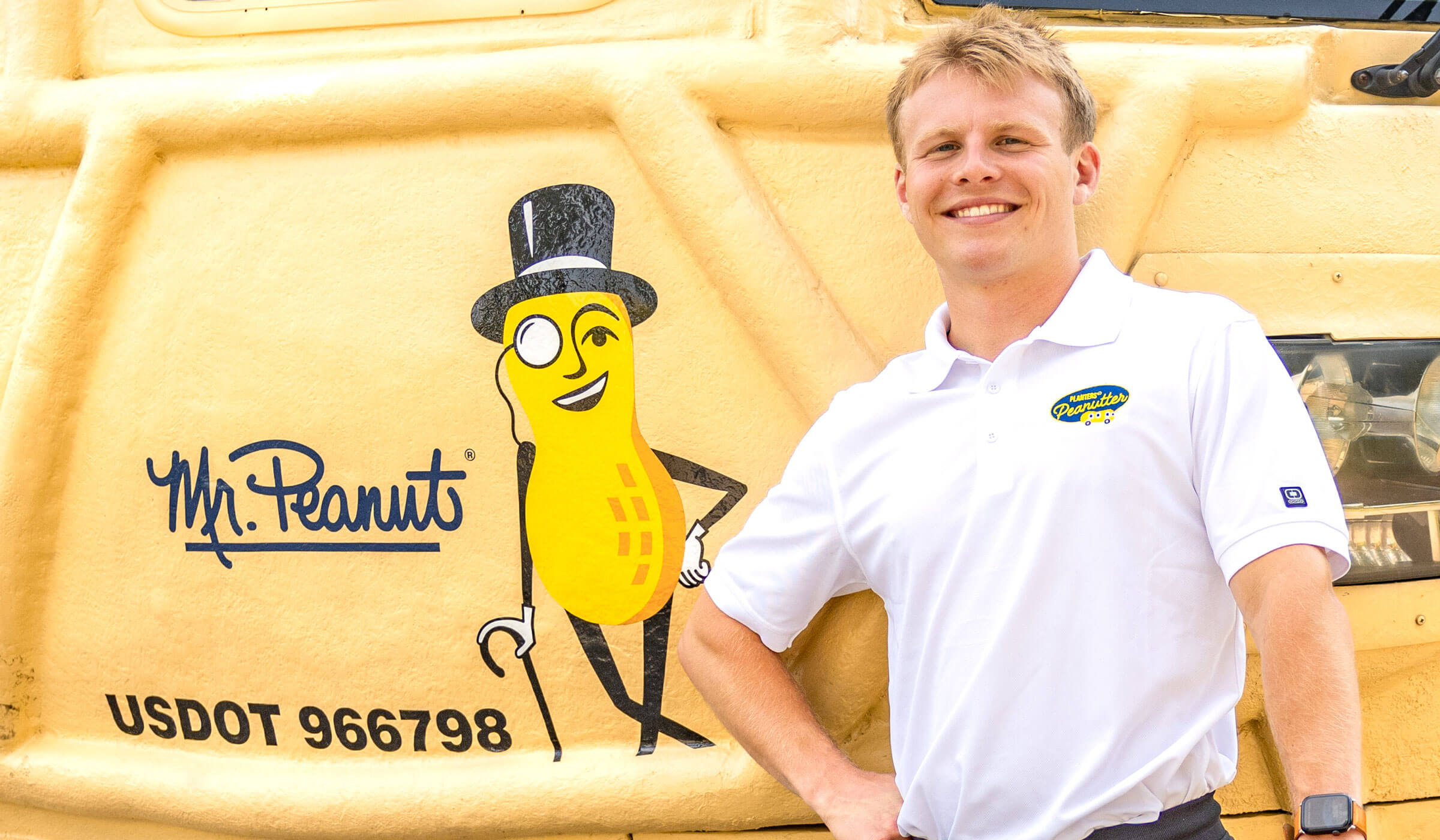 Man smiling in front of the Planters Nutmobile