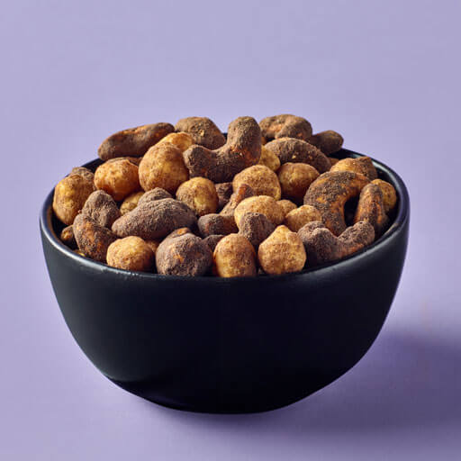 Planters duos espresso hazelnuts and cocoa cashews promotional photo with a purple background