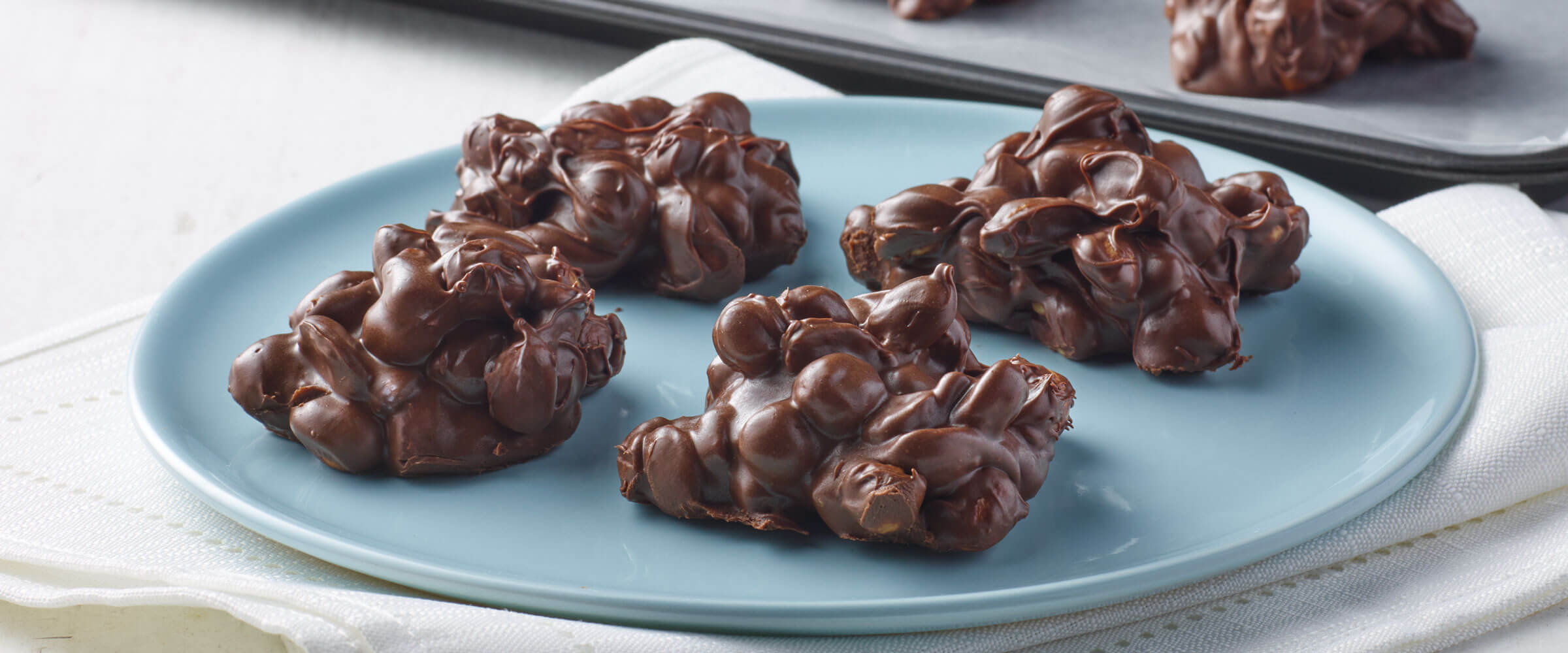 Chocolate peanut clusters on a blue plate