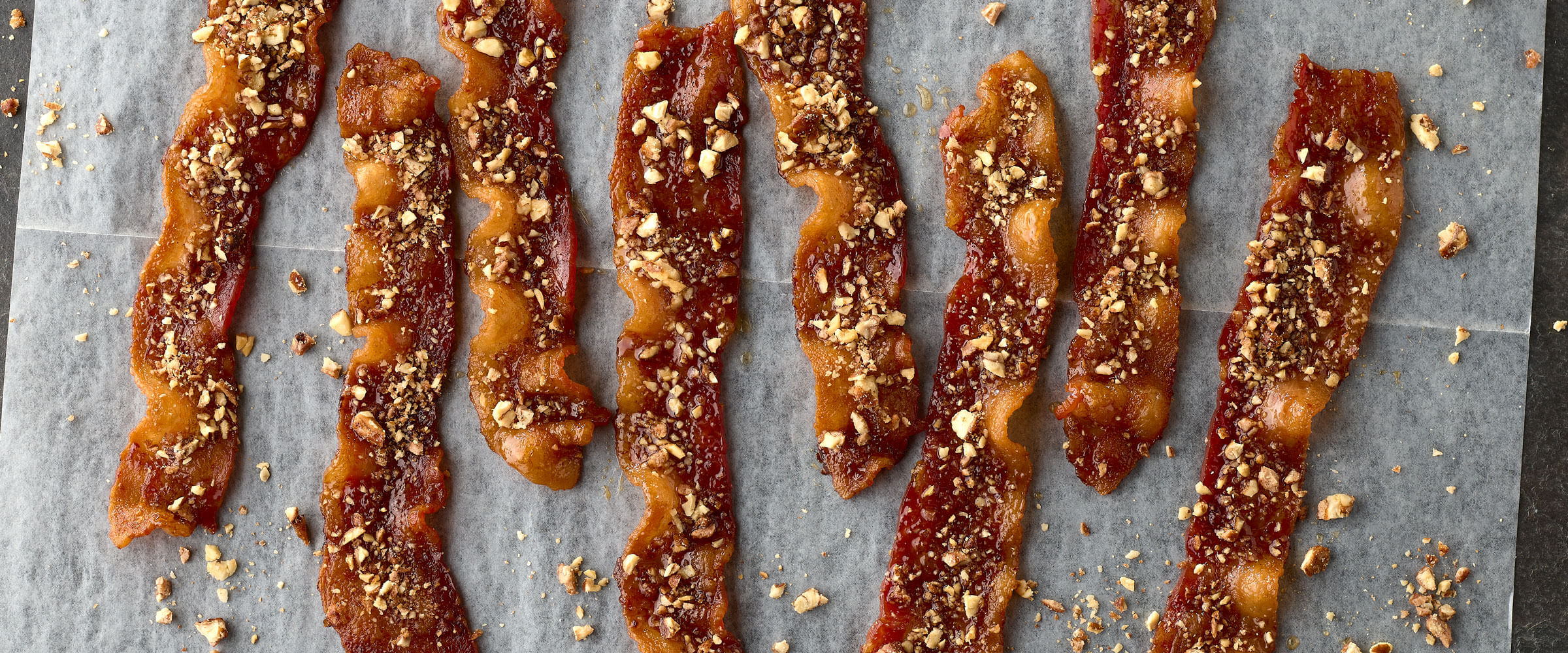 candied pecan bacon recipe with bacon on the baking tray