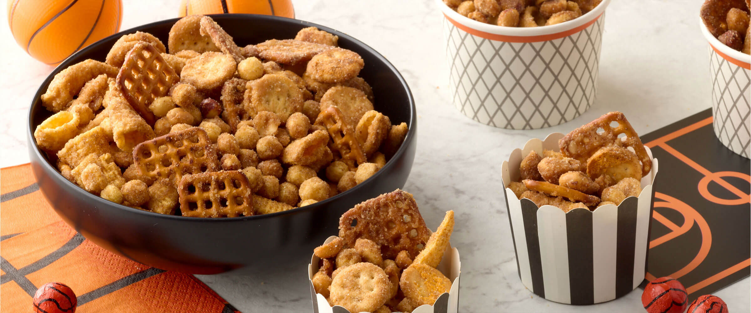 Churro snack mix in a bowl with decor around it on the counter