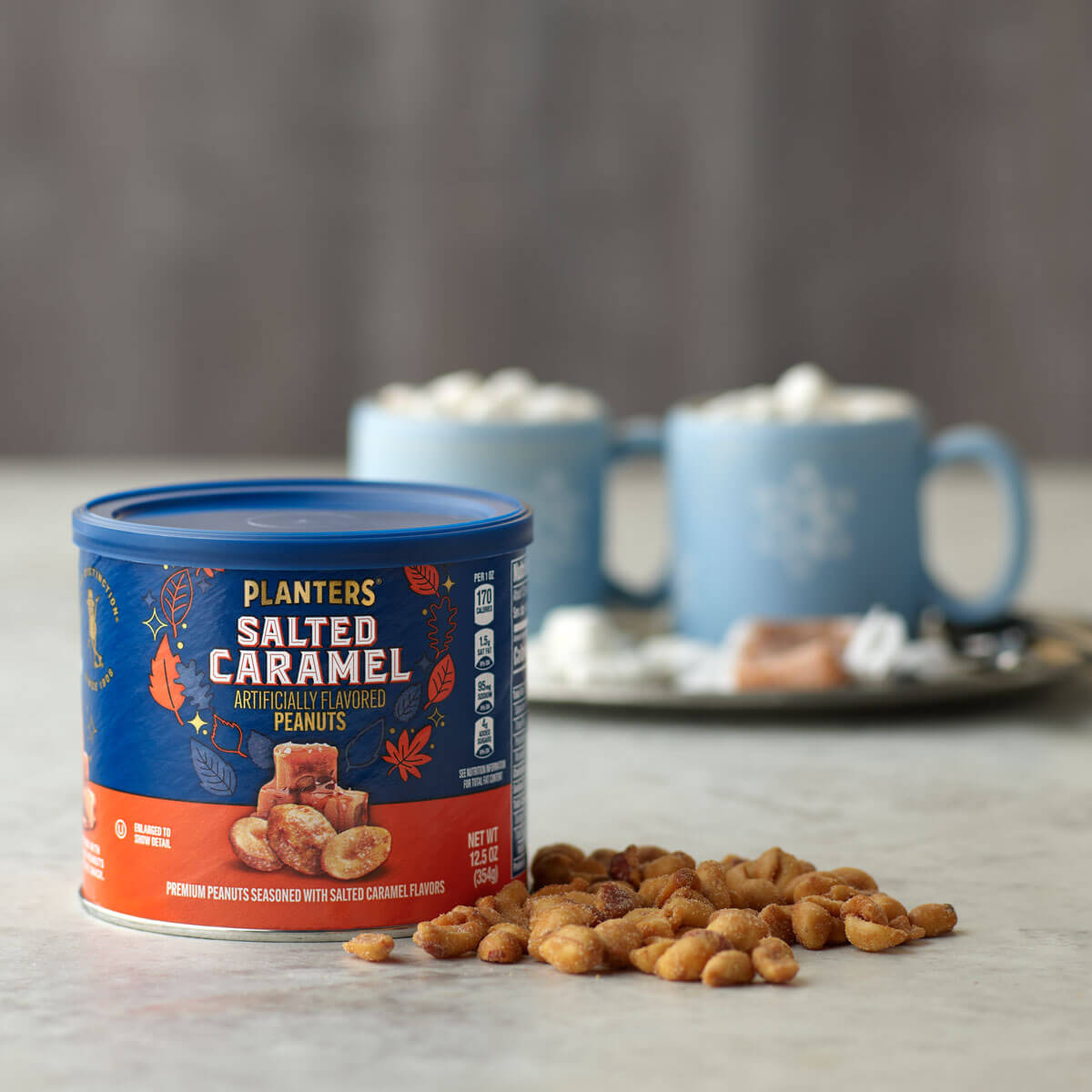 Salted Caramel Peanuts next to cups of Hot Cocoa