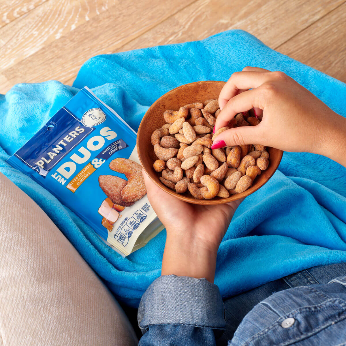 Overhead view of someone eating a bowl of Planters vanilla duos nuts