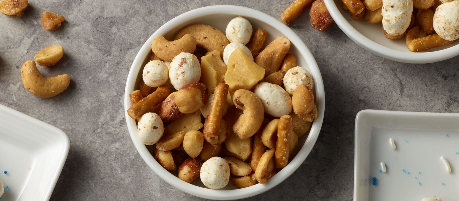 Overhead view of the brittle nut medley in a bowl on the counter