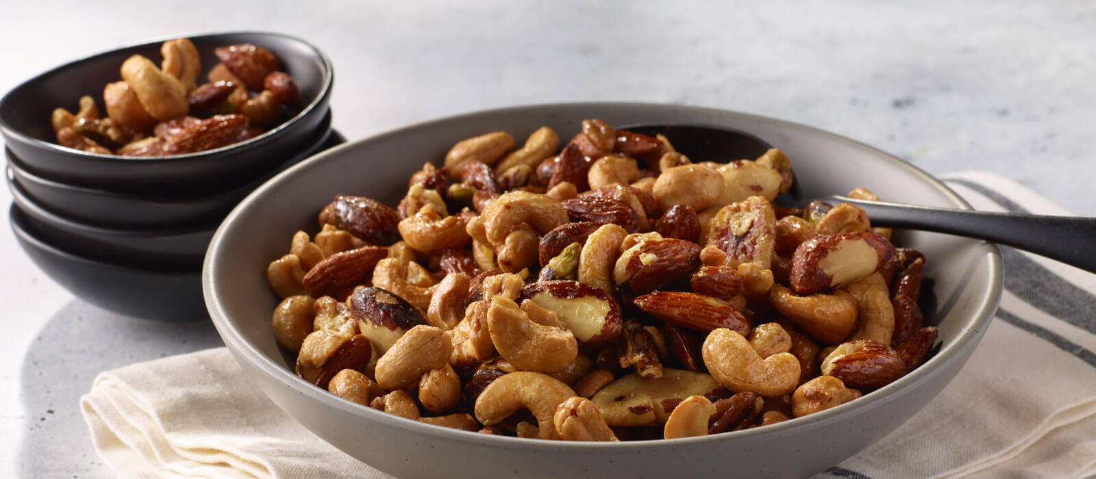 Lightly salted mixed nuts in bowls on the counter