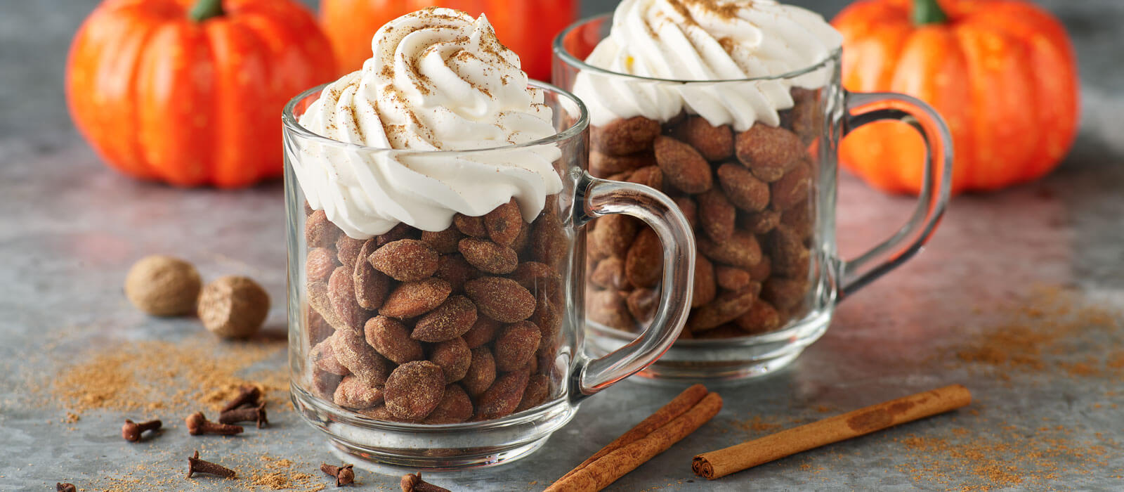 Pumpkin Spice almonds in clear mugs with whipped cream