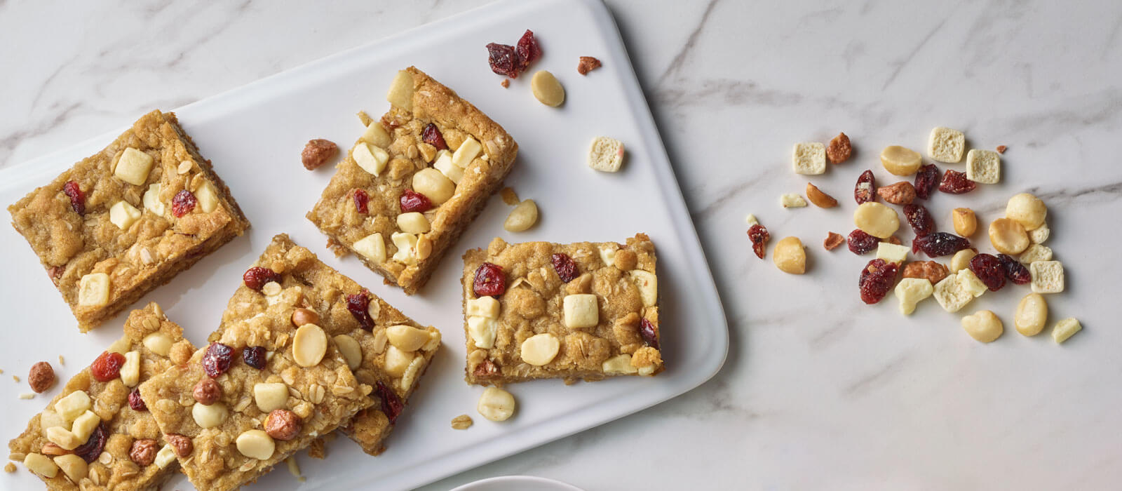 Overhead view of bars made with trail mix on a serving tray