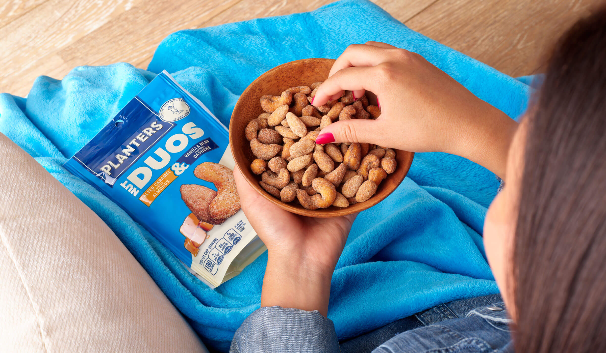 Planters duos salted caramel and vanilla bean person eating a bowl on the couch