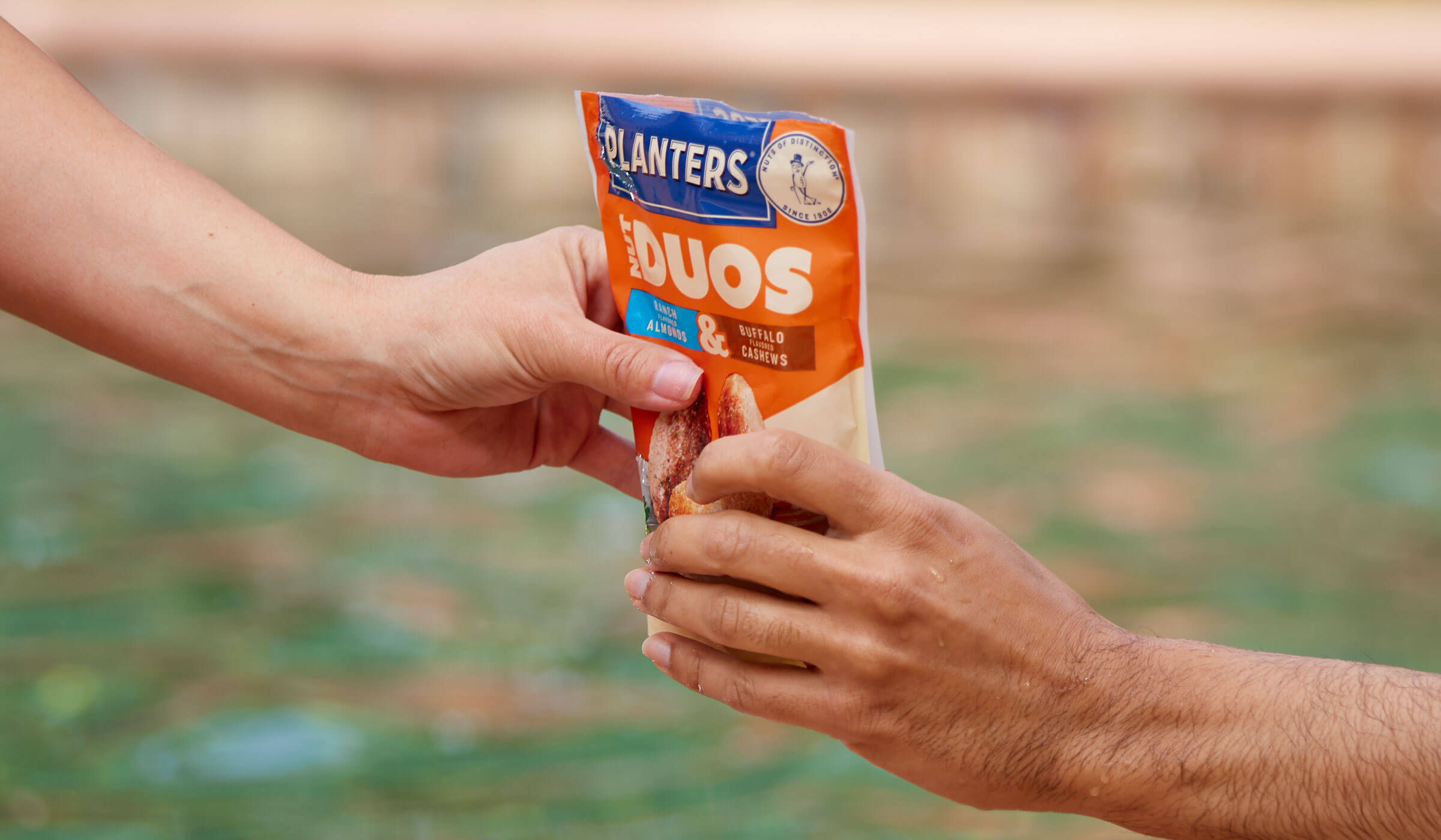 People sharing nut duos buffalo ranch flavor outside