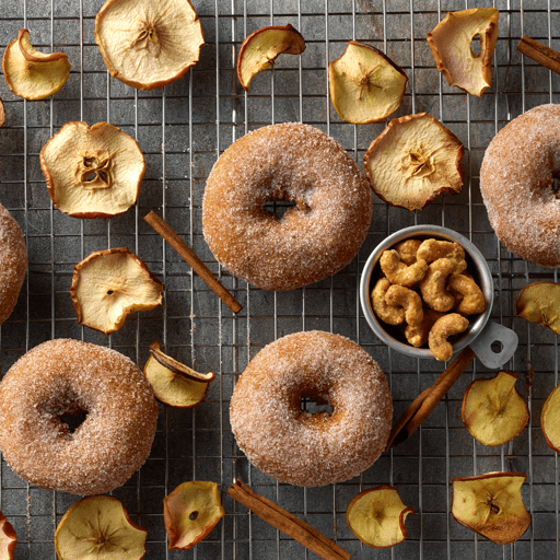 apple cider donuts and cashews on a counter promotional photo