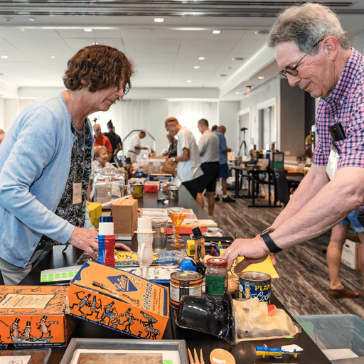 Two People looking at Planter’s Peanuts memorabilia