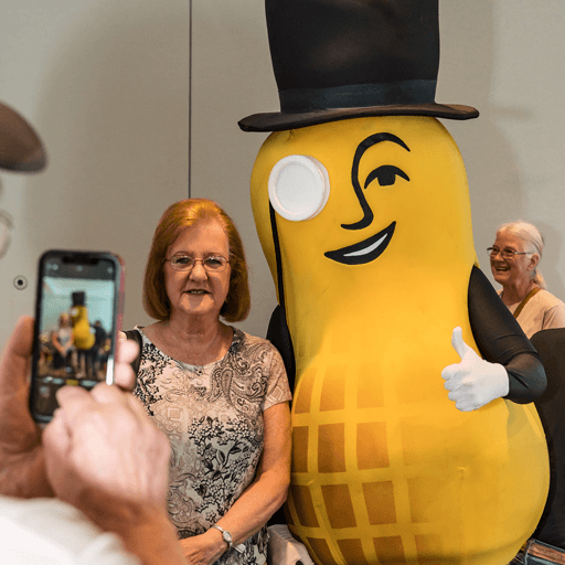 A woman smiling alongside Mr Peanut