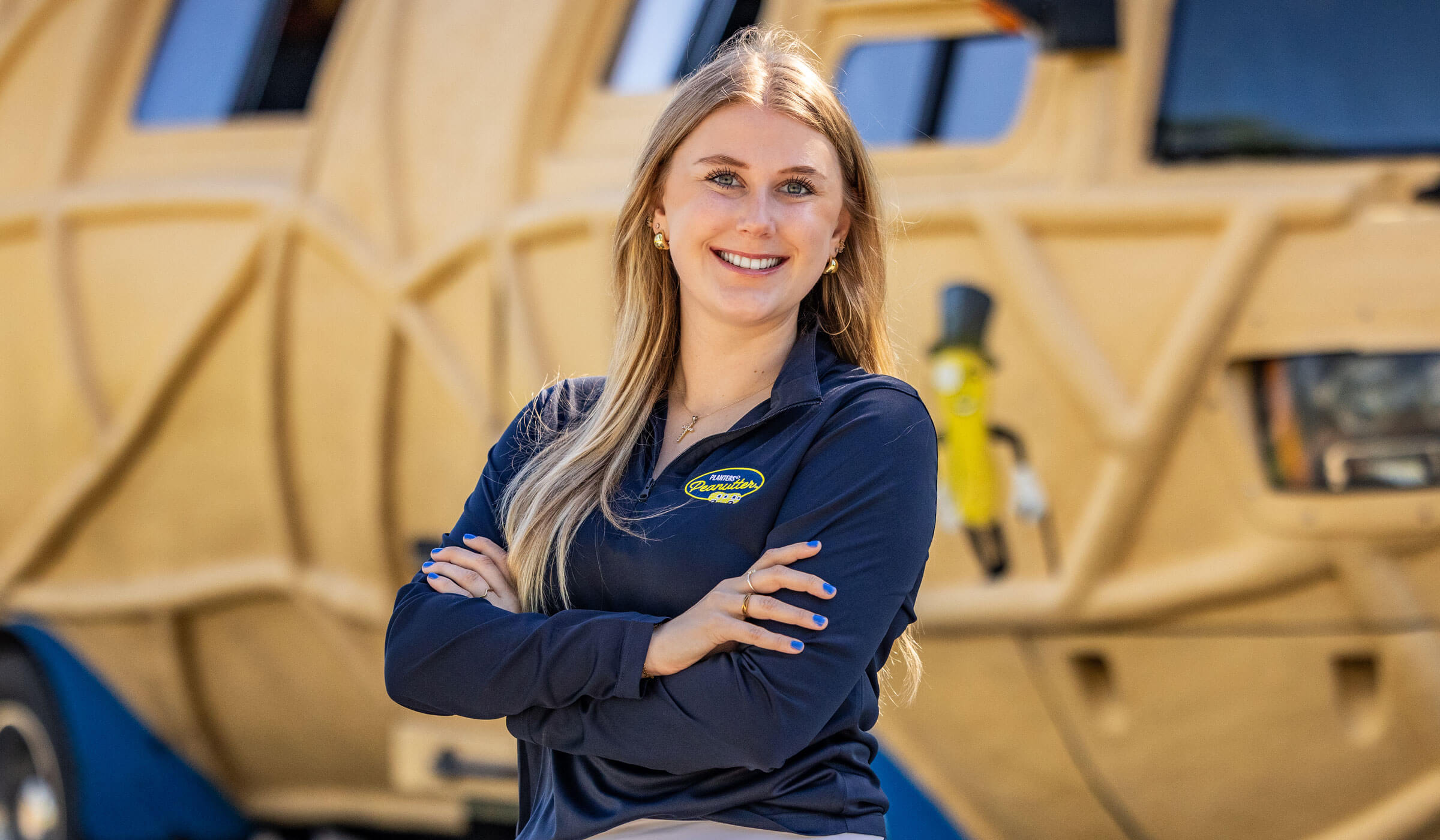Lady smiling in front of the planters nutmobile