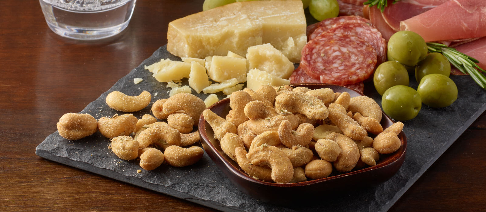 Meat and cheese board featuring Planters Rosemary and Sea Salt Cashews